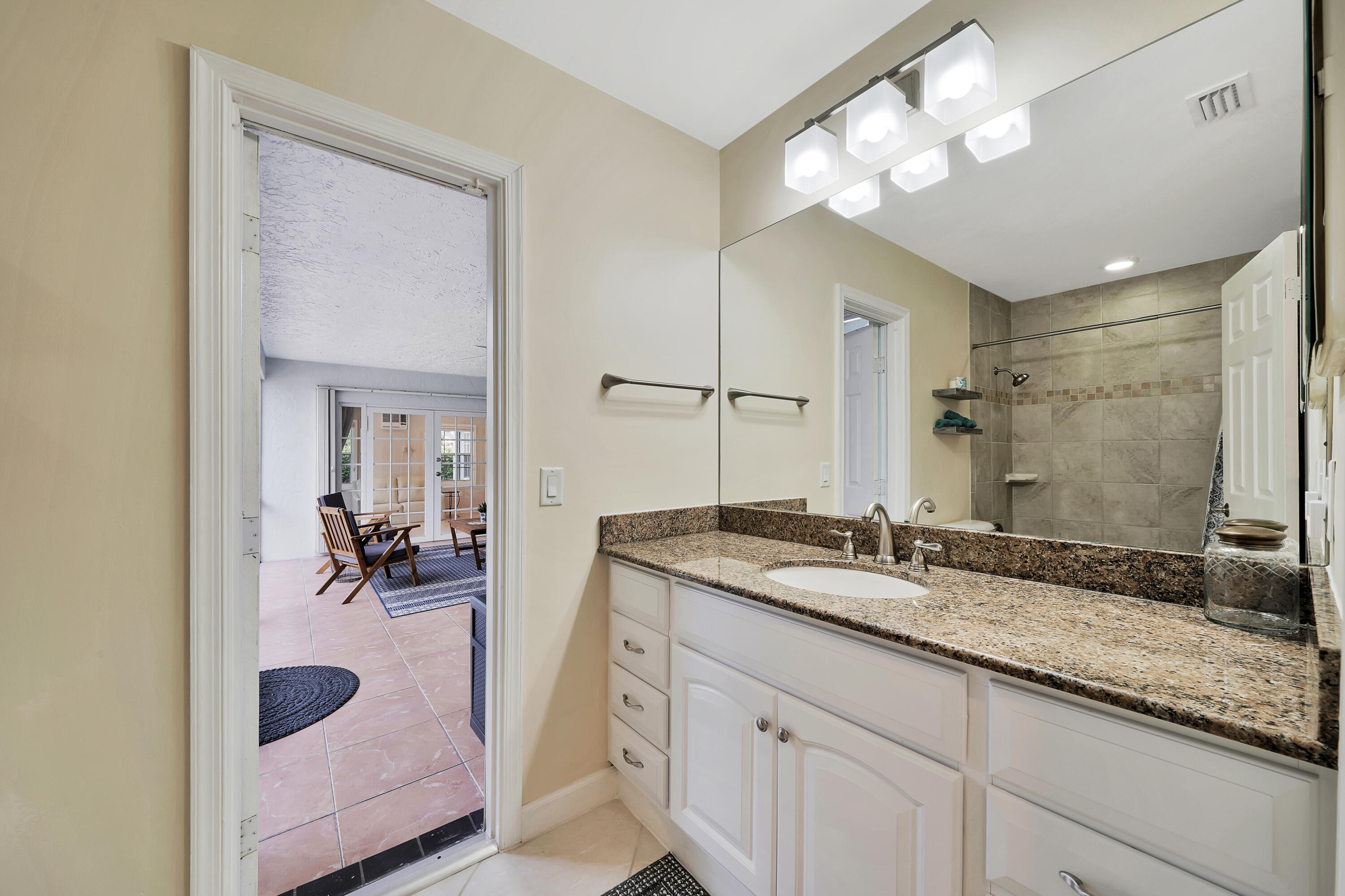 2475 Northwest 25th Street Boca Raton, FL 33431 - Photo 40 of 72 a en suite bathroom with a granite countertop sink and a mirror