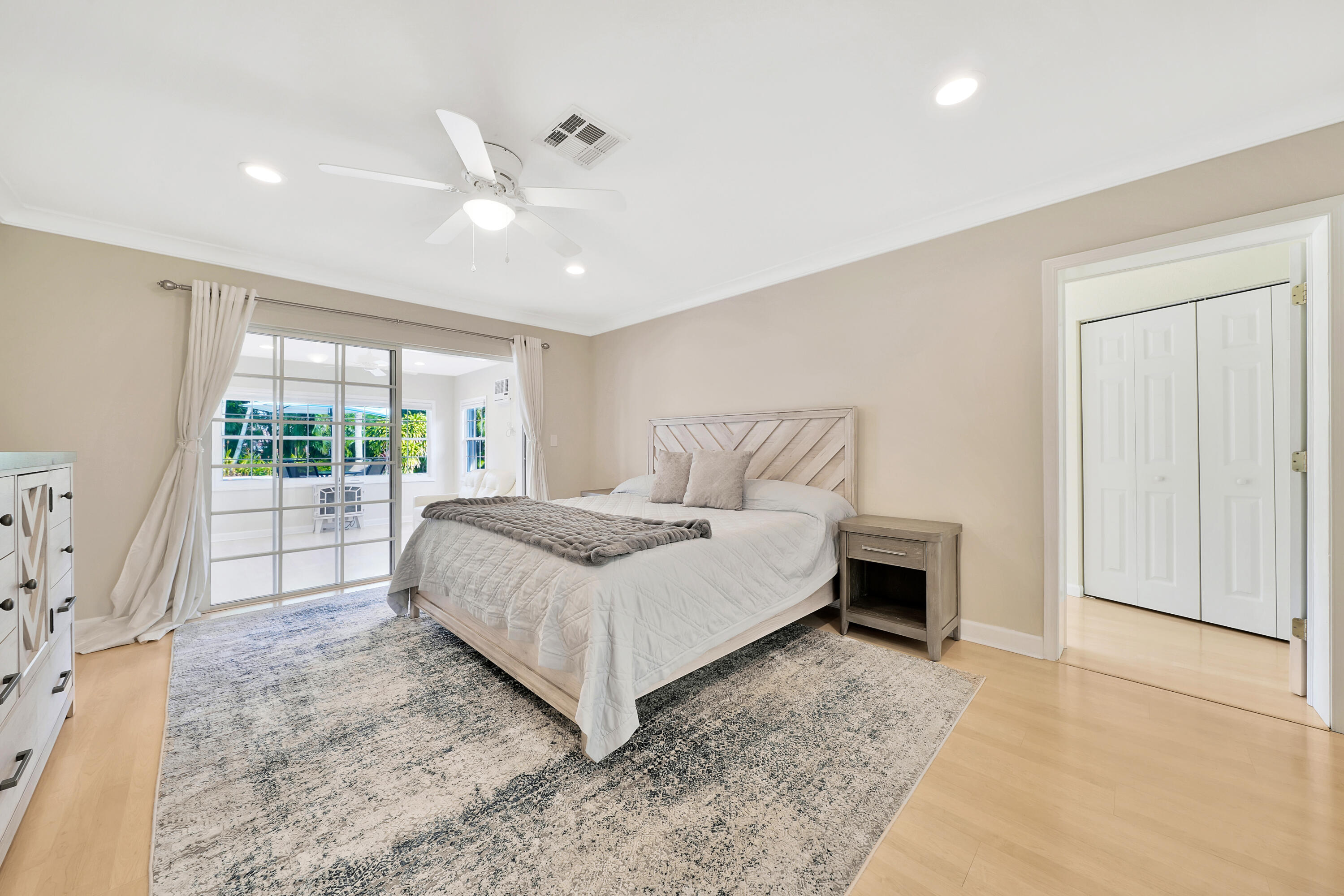 2475 Northwest 25th Street Boca Raton, FL 33431 - Photo 44 of 72 a bedroom with a large bed and a large window with outer view