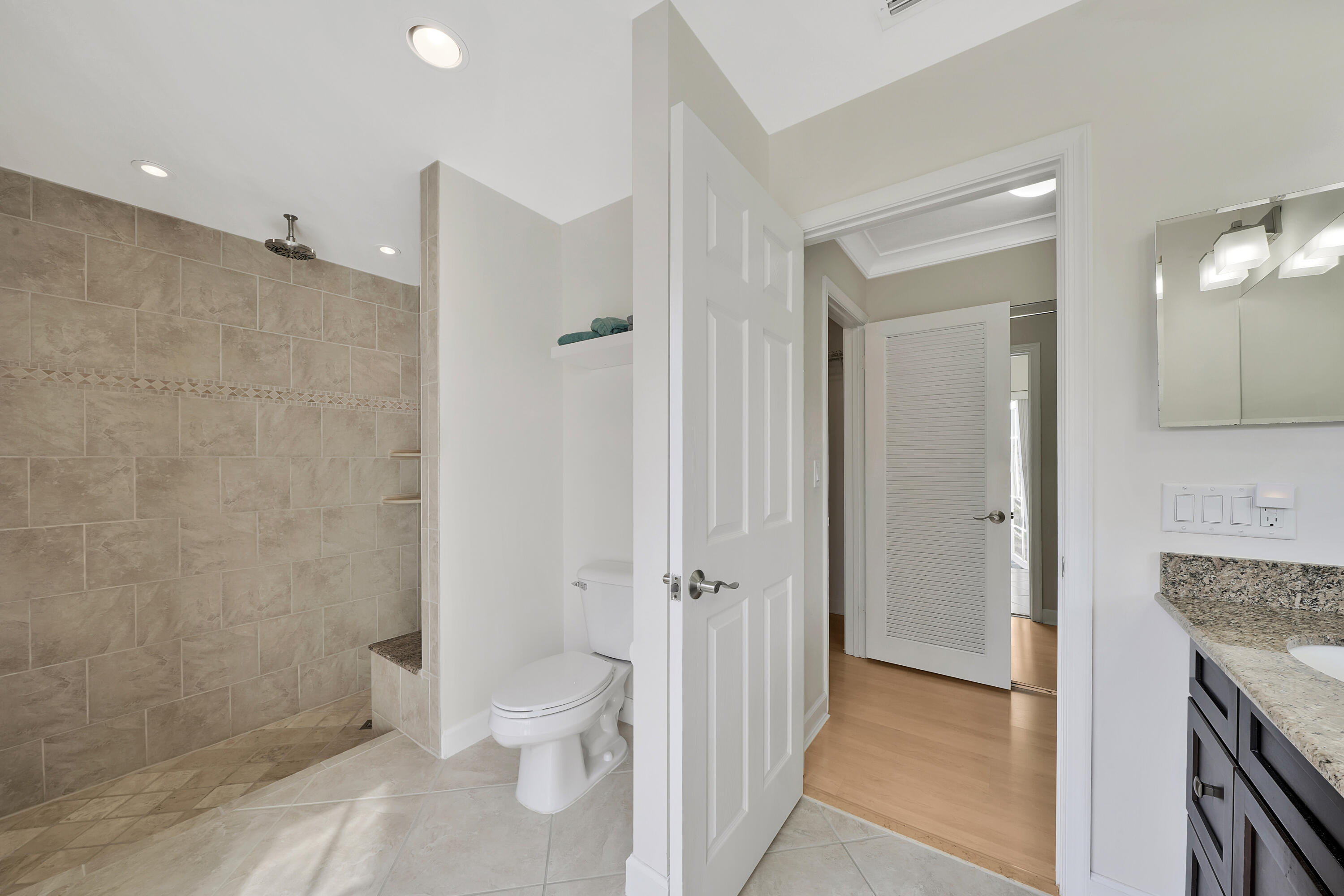 2475 Northwest 25th Street Boca Raton, FL 33431 - Photo 57 of 72 a bathroom with a granite countertop sink a toilet and shower