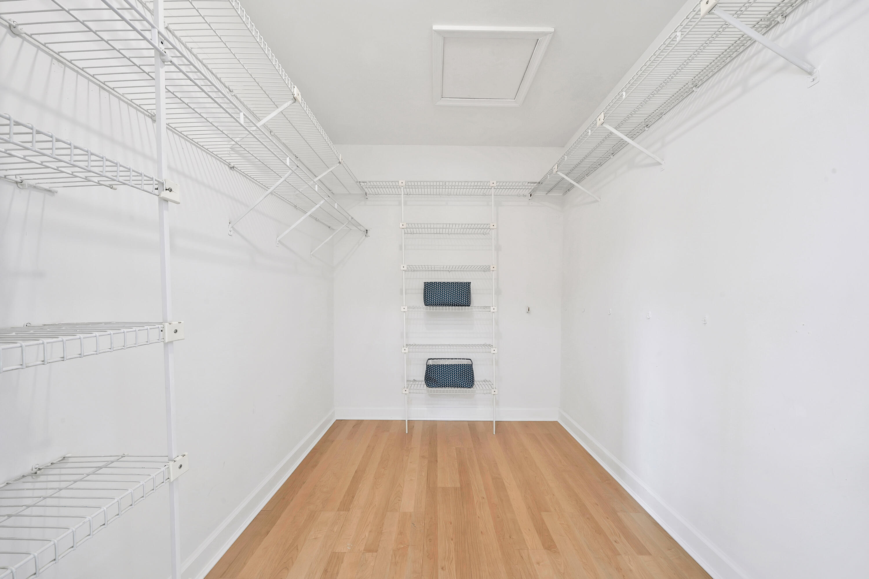 2475 Northwest 25th Street Boca Raton, FL 33431 - Photo 59 of 72 a view of a room with wooden floor and white walls