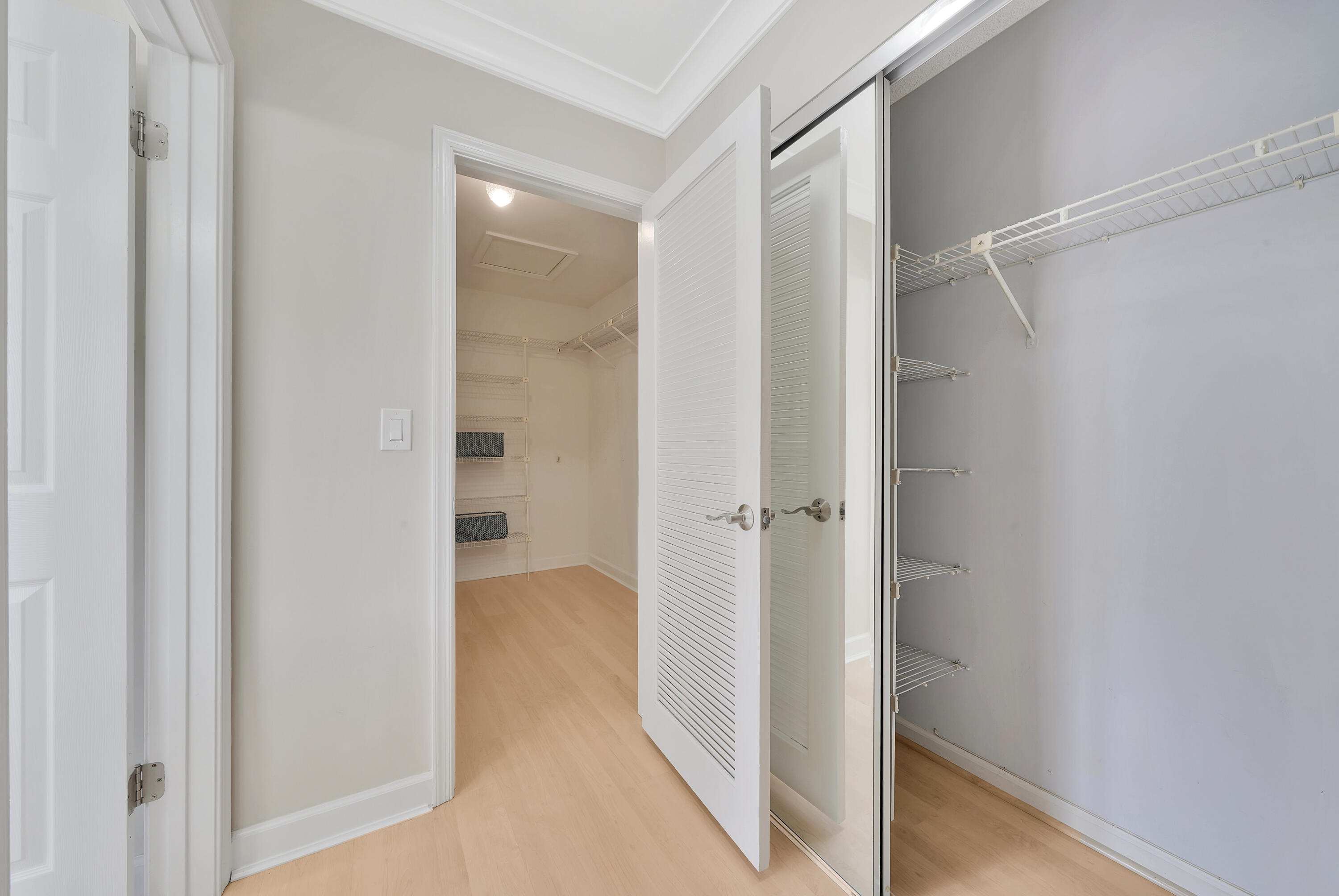 2475 Northwest 25th Street Boca Raton, FL 33431 - Photo 60 of 72 a view of a hallway with closet and wooden floor