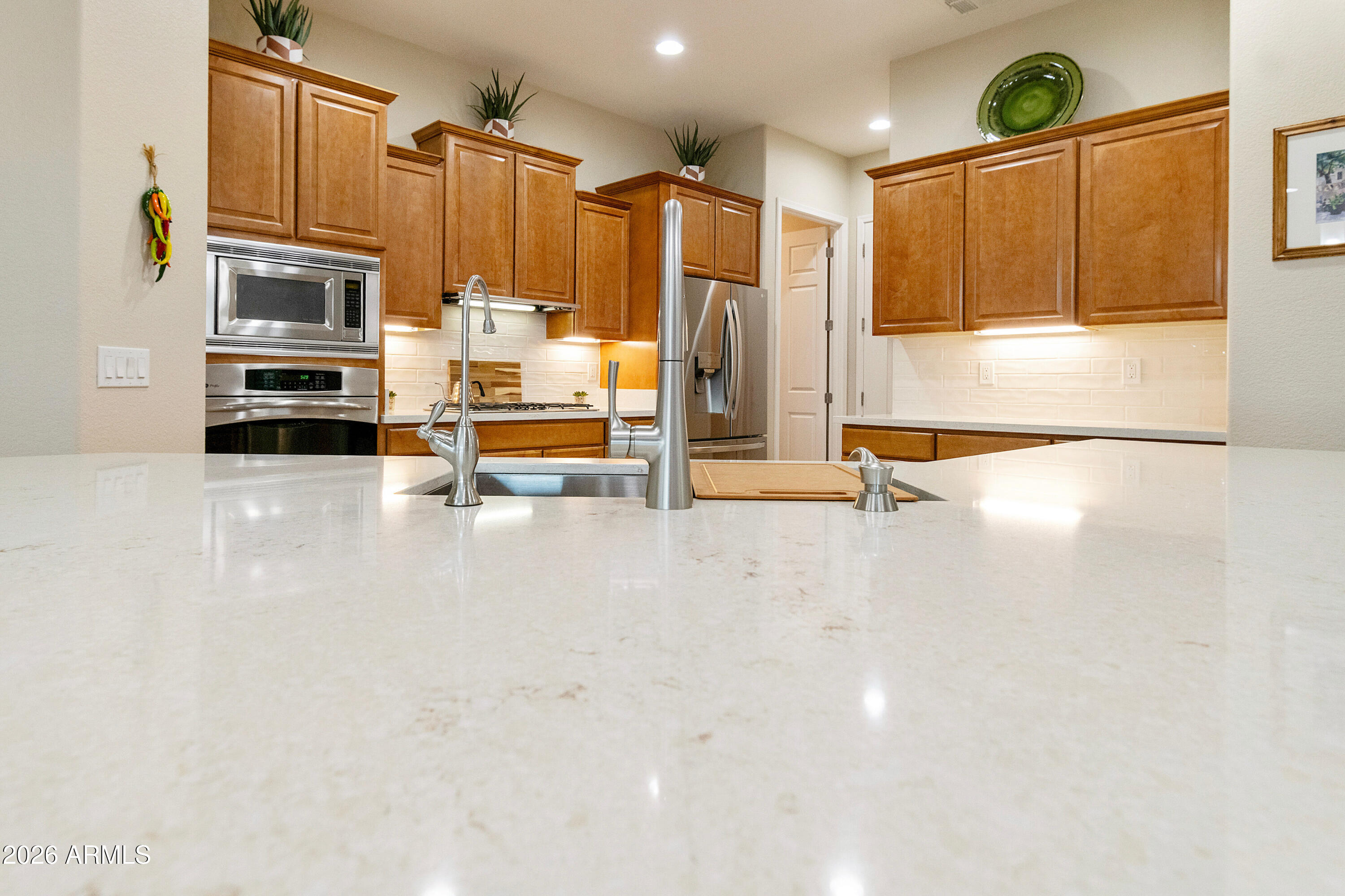 5291 South Sugarberry Court Gilbert, AZ 85298 - Photo 31 of 67 a view of kitchen with stainless steel appliances wooden floor and window