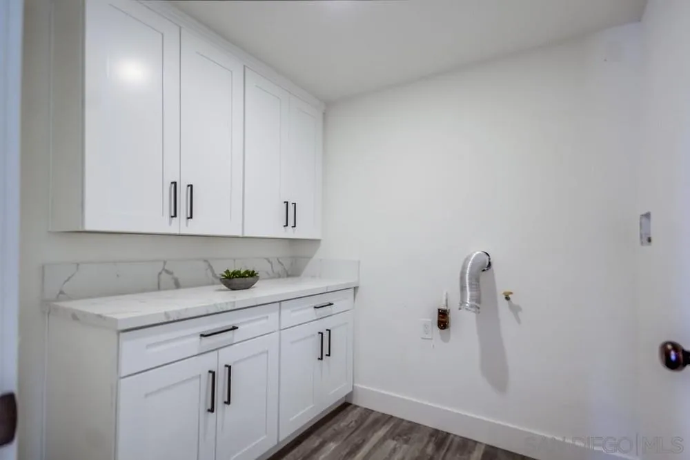 344 Mountain View Road El Cajon, CA 92021 - Photo 13 of 38 a kitchen with white cabinets and sink