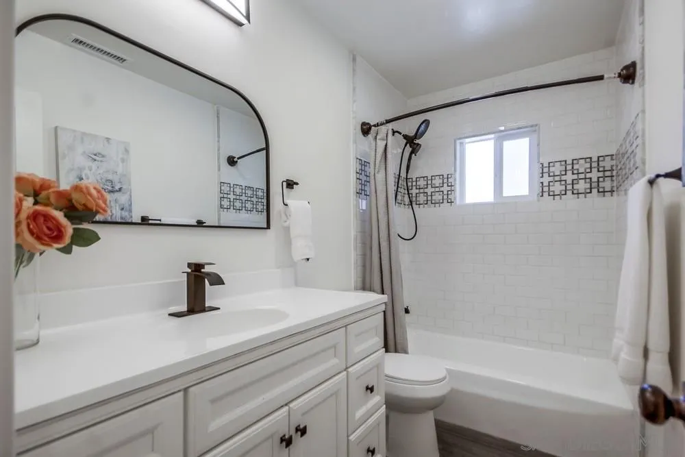 344 Mountain View Road El Cajon, CA 92021 - Photo 16 of 38 a bathroom with a sink a toilet and a mirror