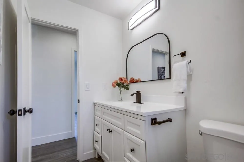 344 Mountain View Road El Cajon, CA 92021 - Photo 17 of 38 a bathroom with a sink and a mirror