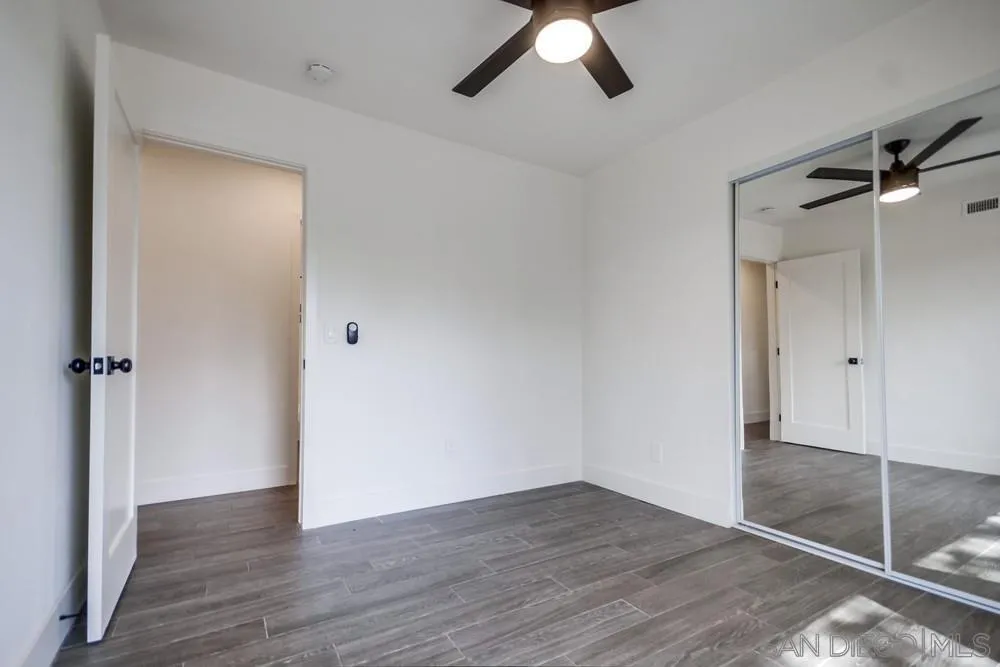 344 Mountain View Road El Cajon, CA 92021 - Photo 20 of 38 an empty room with wooden floor closet and windows
