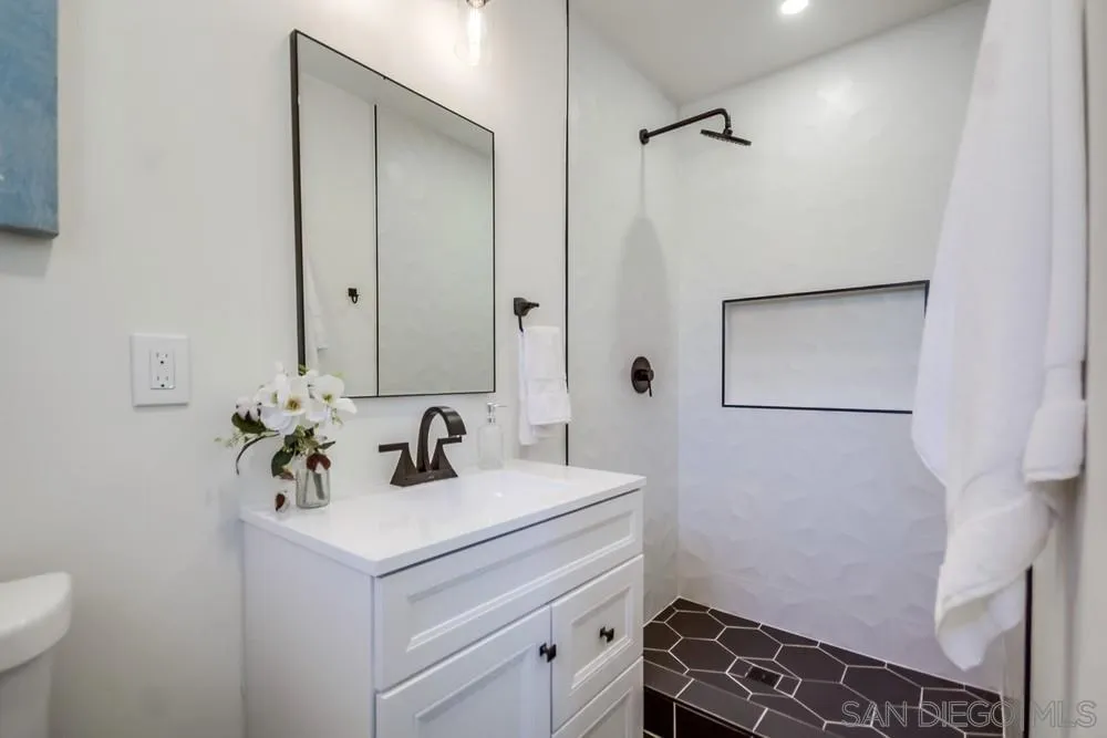 344 Mountain View Road El Cajon, CA 92021 - Photo 26 of 38 a bathroom with a sink and a mirror