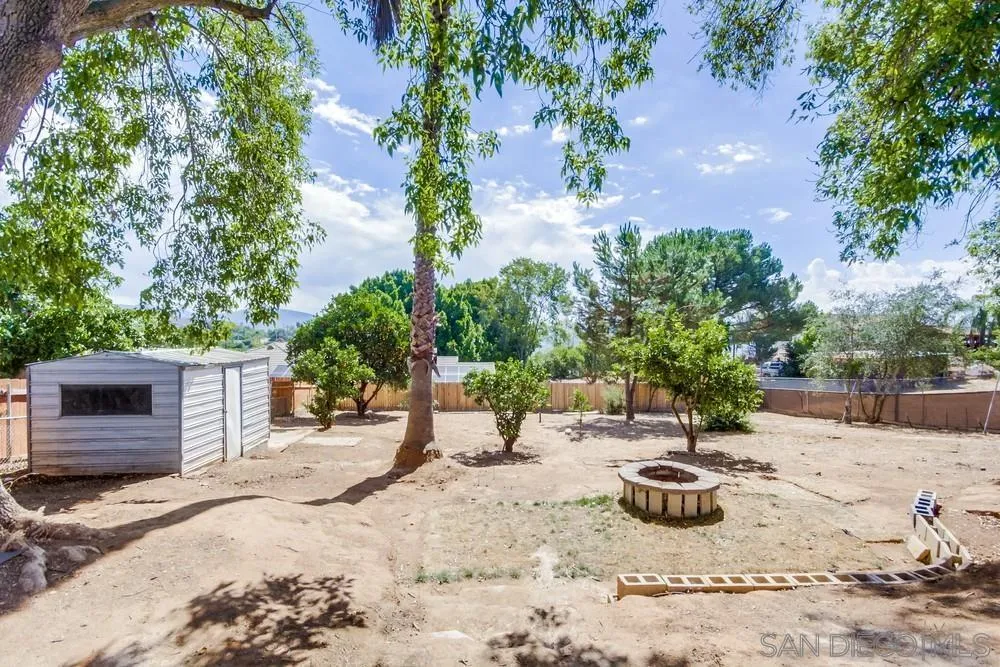 344 Mountain View Road El Cajon, CA 92021 - Photo 32 of 38 a view of a backyard with a fountain and large trees