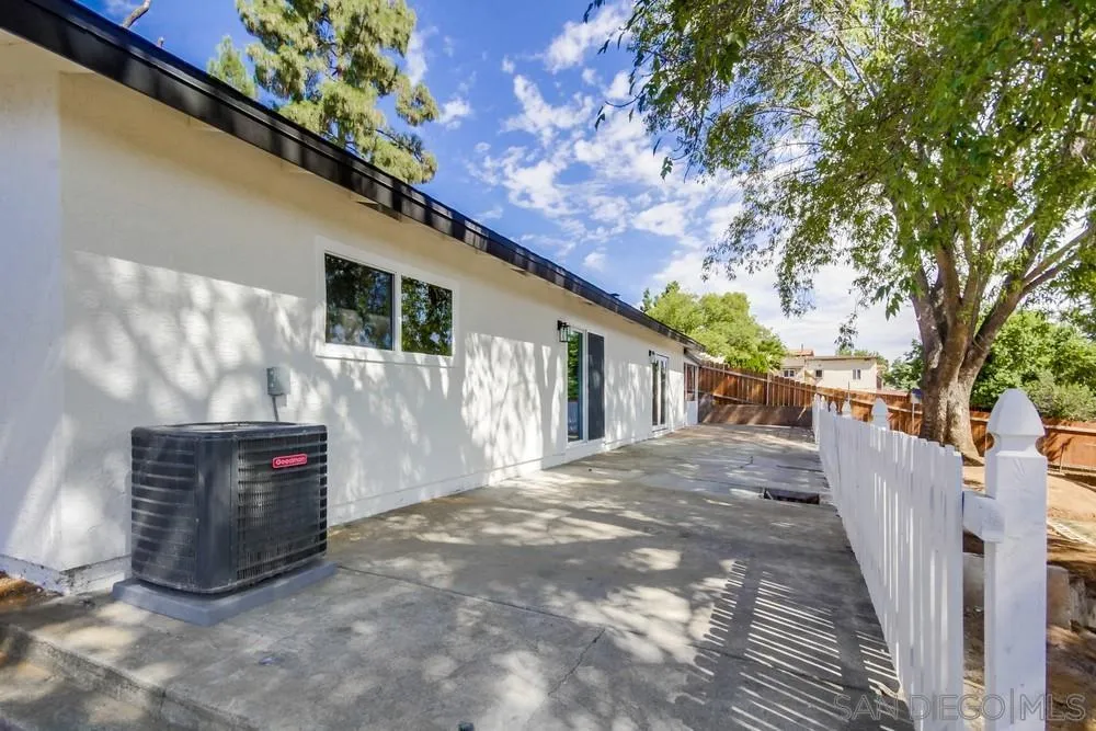 344 Mountain View Road El Cajon, CA 92021 - Photo 36 of 38 a view of a house with a small yard and a large tree