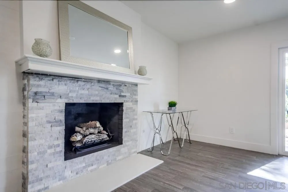344 Mountain View Road El Cajon, CA 92021 - Photo 7 of 38 a living room with a fireplace and a rug