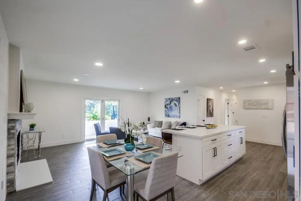 344 Mountain View Road El Cajon, CA 92021 - Photo 9 of 38 a kitchen with a dining table chairs wooden floor appliances and cabinets