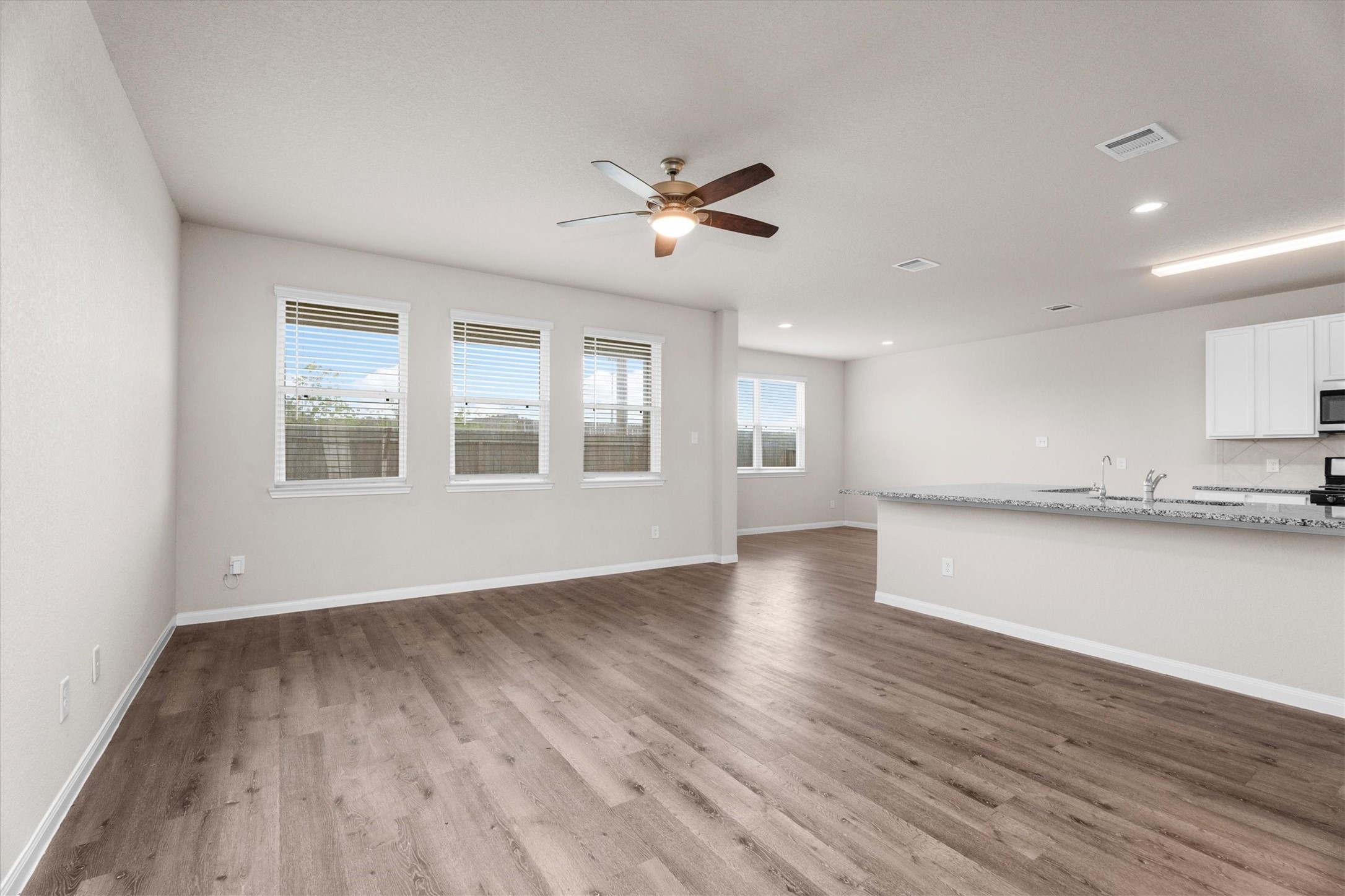 23622 Goodfellow Drive Spring, TX 77373 - Photo 11 of 34 a view of an empty room with wooden floor and a window