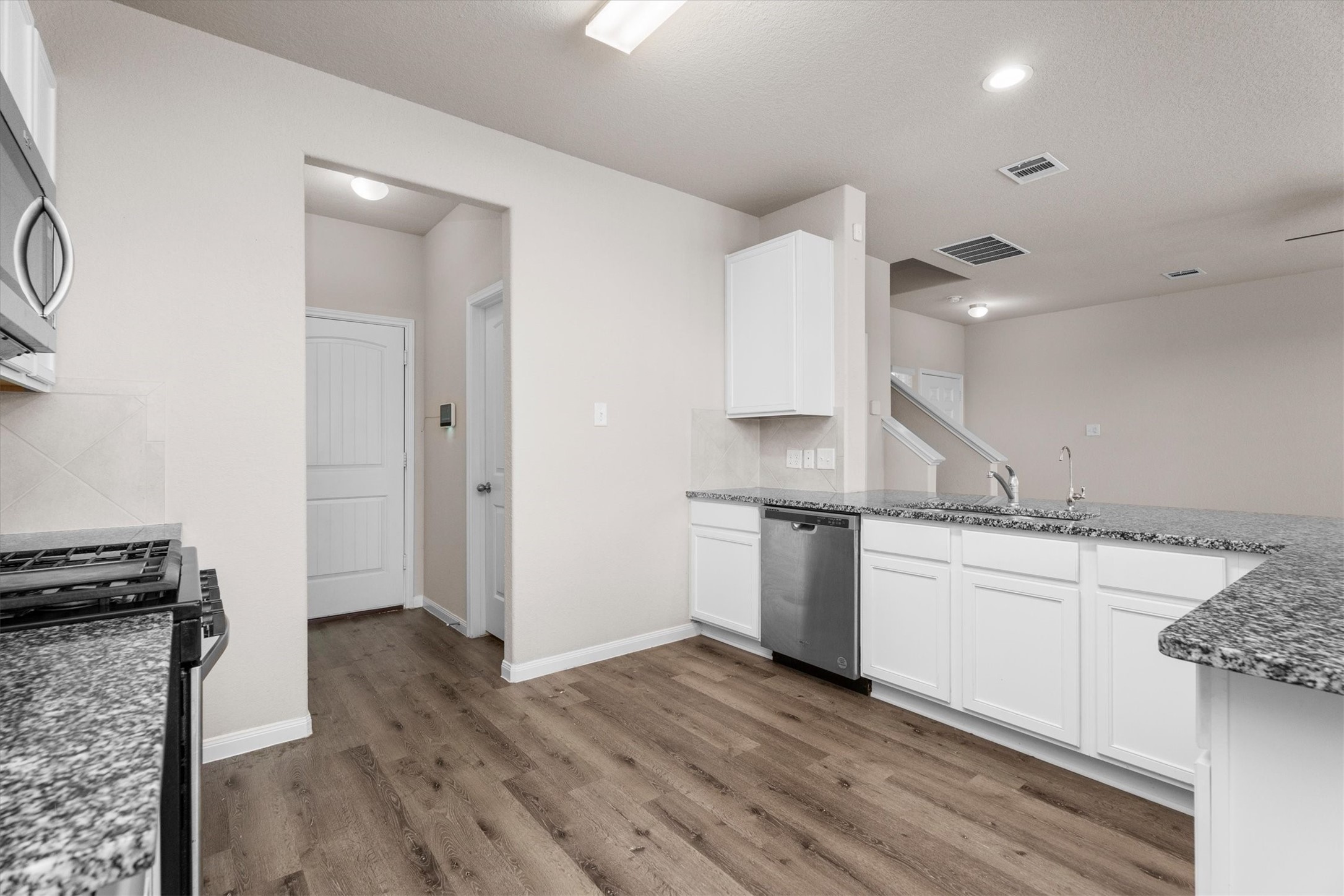23622 Goodfellow Drive Spring, TX 77373 - Photo 12 of 34 a kitchen with granite countertop a sink and a stove top oven