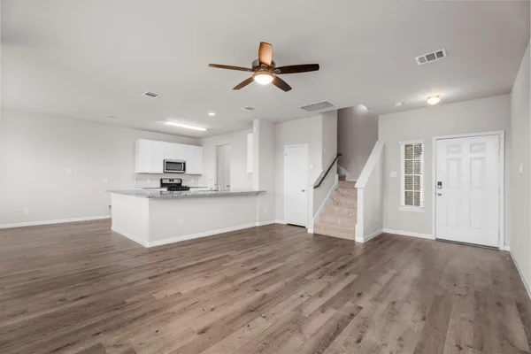a view of kitchen with wooden floor and electronic appliances