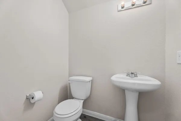 a bathroom with a sink a toilet and mirror