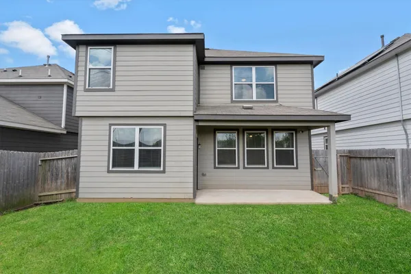 a view of a house with a yard and front view of a house