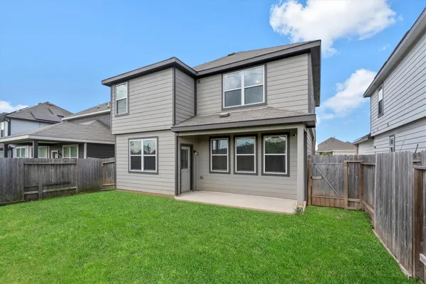 a view of house with backyard