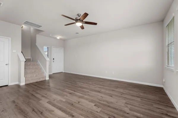 wooden floor in an empty room with a window