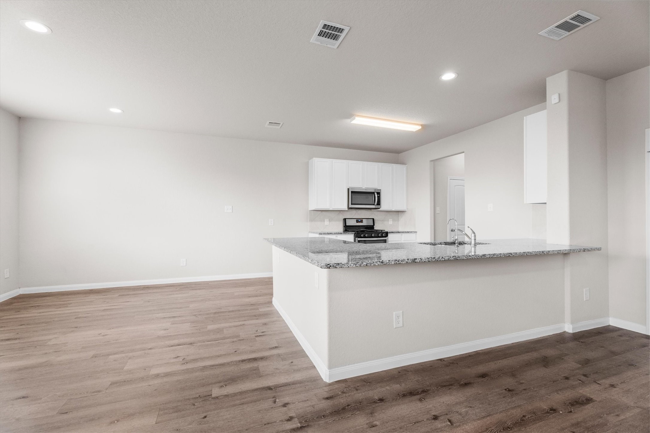 23622 Goodfellow Drive Spring, TX 77373 - Photo 9 of 34 a kitchen with stainless steel appliances granite countertop a sink a stove and a wooden floors
