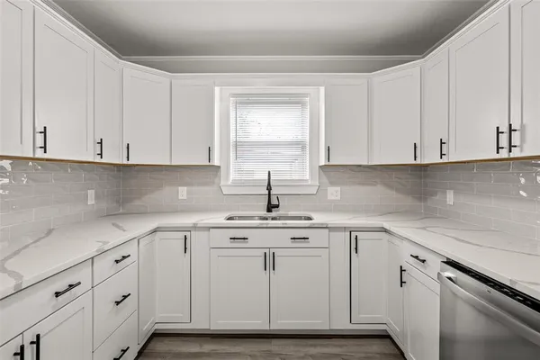a view with cabinets stainless steel appliances and a sink