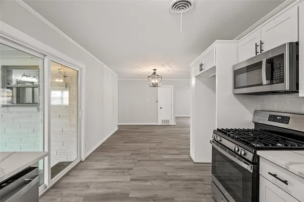 a kitchen with stainless steel appliances granite countertop a stove and a microwave