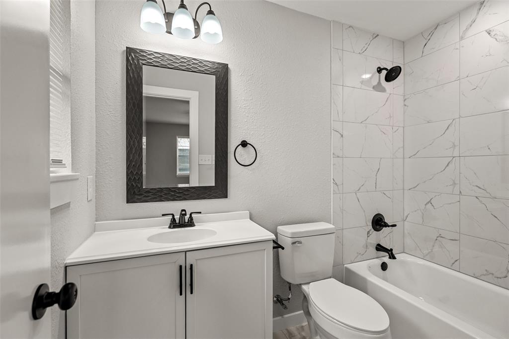 1506 West Main Street Denison, TX 75020 - Photo 18 of 38 a bathroom with a sink a toilet and shower