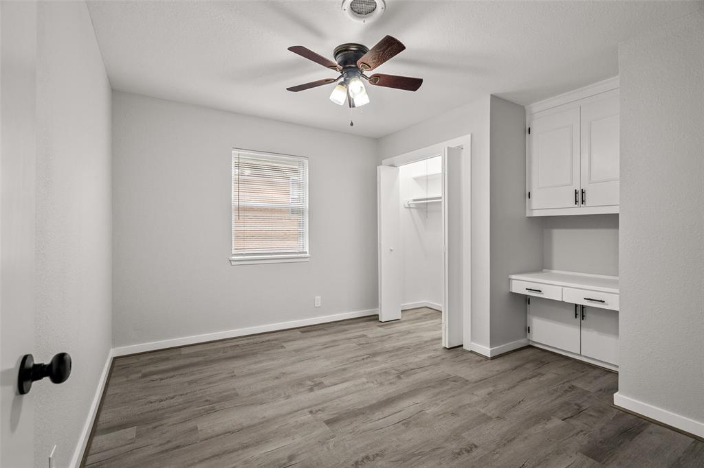 1506 West Main Street Denison, TX 75020 - Photo 20 of 38 wooden floor in an empty room with a window