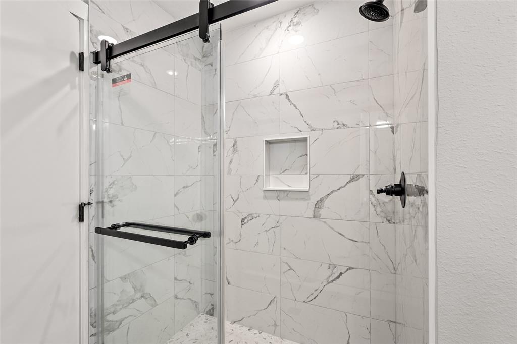 1506 West Main Street Denison, TX 75020 - Photo 22 of 38 a bathroom with a shower