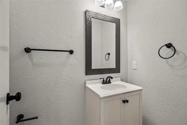 a bathroom with a sink and mirror