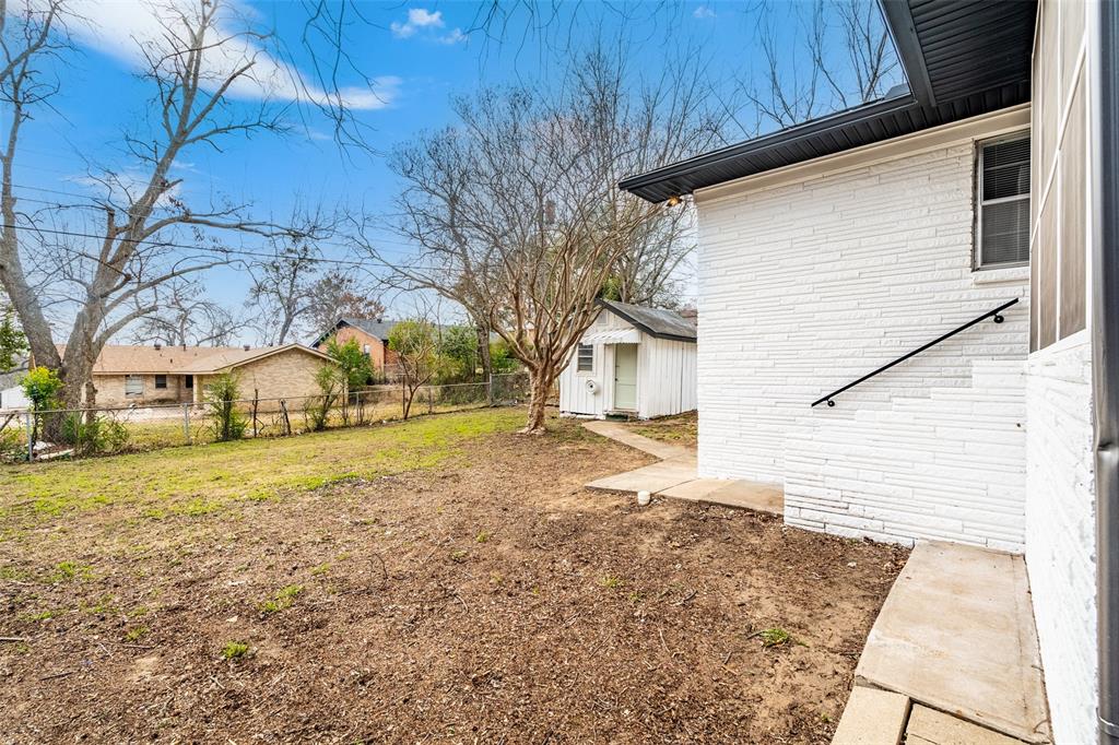 1506 West Main Street Denison, TX 75020 - Photo 35 of 38 a view of a yard with a house and a large tree