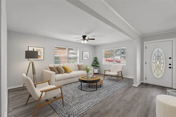 a living room with furniture a clock and a window