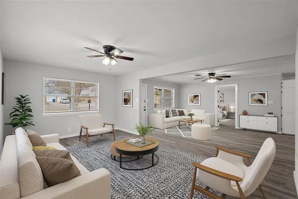 a living room with furniture and wooden floor