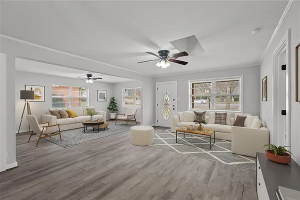 a living room with furniture and wooden floor