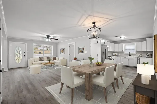 a dining room with wooden floor a chandelier a wooden table and chairs