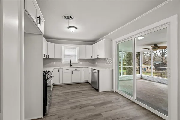 a kitchen with white cabinets and white appliances