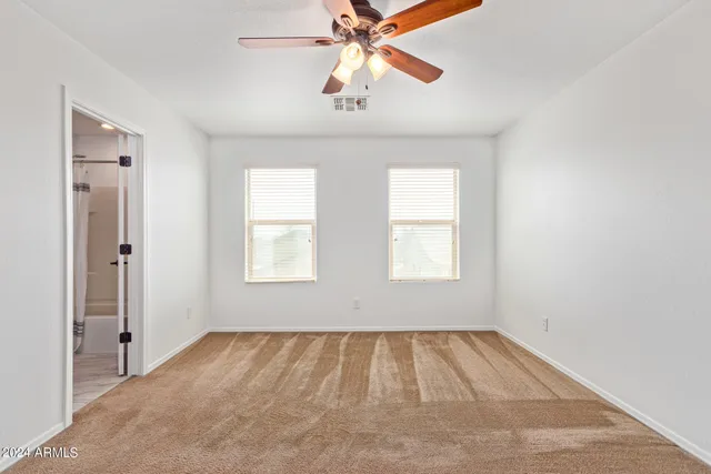 a view of room with window and ceiling fan