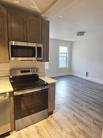 a kitchen with wood cabinets and a stove top oven