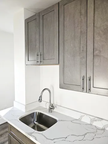 a kitchen with a sink and cabinets