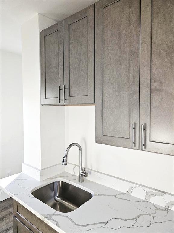 323 Chatham Street, Unit 3 Lynn, MA 01902 - Photo 4 of 13 a kitchen with a sink and cabinets