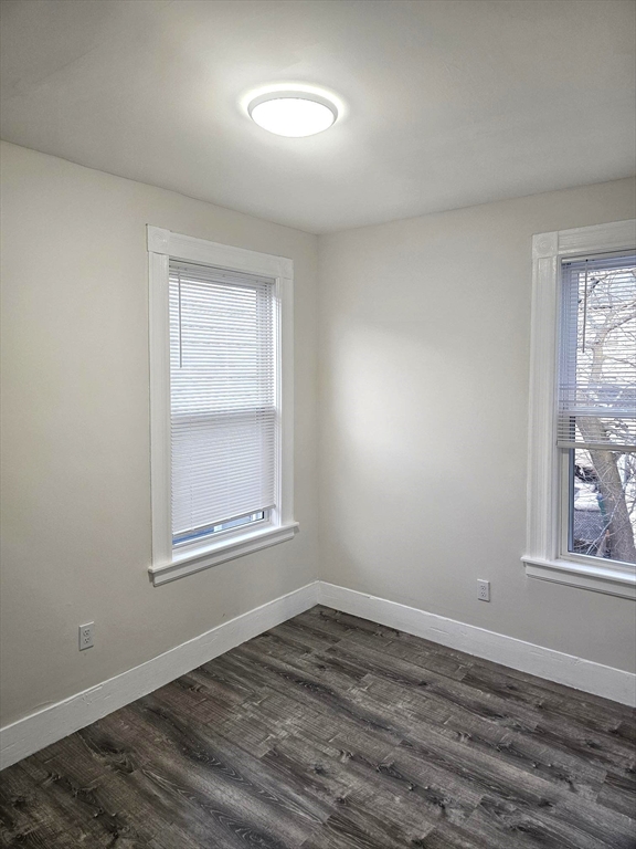 323 Chatham Street, Unit 3 Lynn, MA 01902 - Photo 9 of 13 an empty room with wooden floor and windows