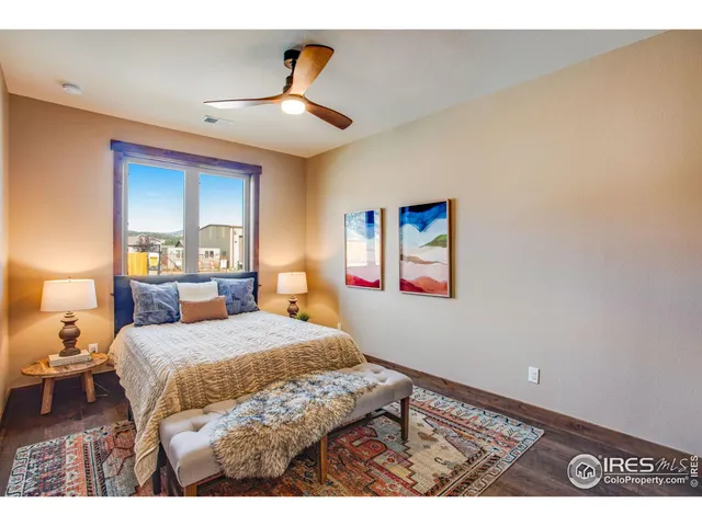 a bedroom with a bed and a painting on the wall