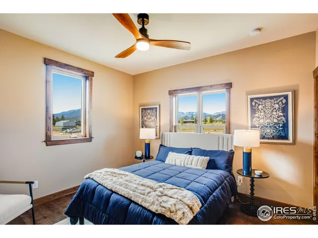 a living room with couches and large window with outer view