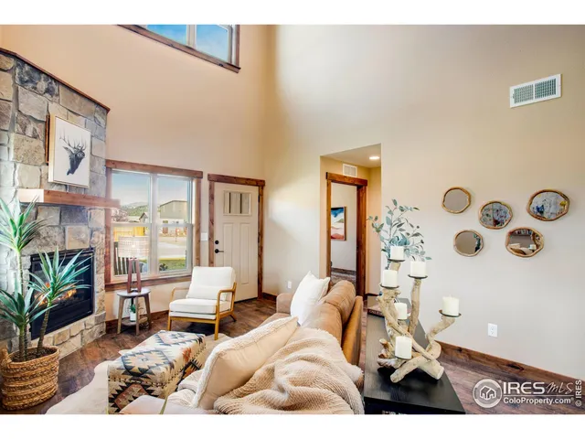 a living room with furniture and a floor to ceiling window