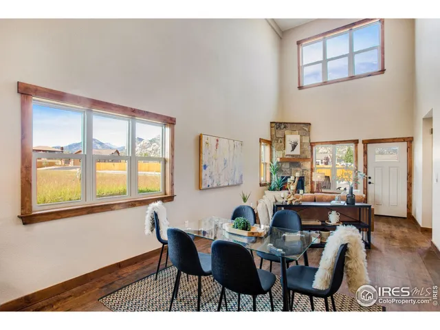 a view of a dining room with furniture and a window