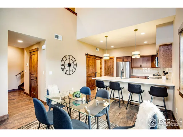 a living room with stainless steel appliances kitchen island granite countertop furniture and a large window