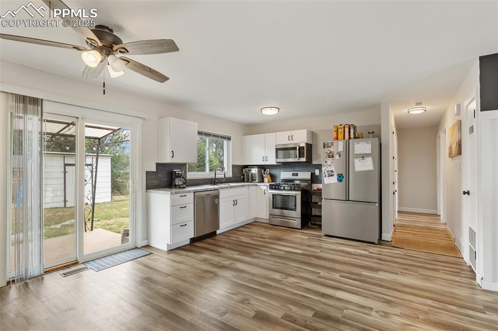 509 Inca Drive Colorado Springs, CO 80911 - Photo 12 of 30 a kitchen with stainless steel appliances kitchen island granite countertop a refrigerator and a sink