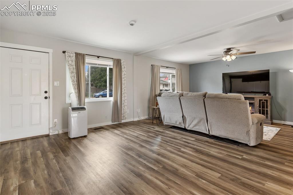 509 Inca Drive Colorado Springs, CO 80911 - Photo 15 of 30 a view of a livingroom with wooden floor and a ceiling fan