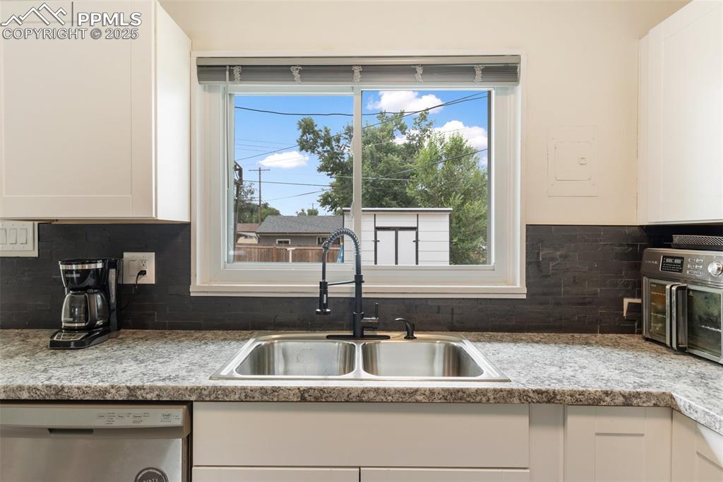 509 Inca Drive Colorado Springs, CO 80911 - Photo 17 of 30 a kitchen with granite countertop a sink and a window