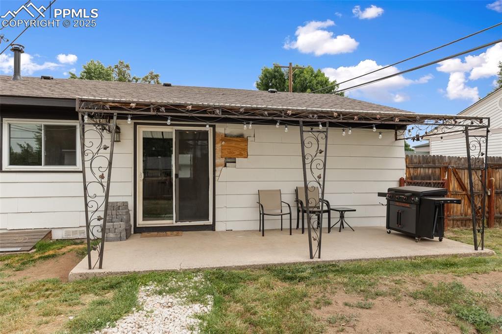 509 Inca Drive Colorado Springs, CO 80911 - Photo 29 of 30 a view of a patio with table and chairs with wooden floor and fence