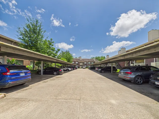 a view of a cars park in front of a building